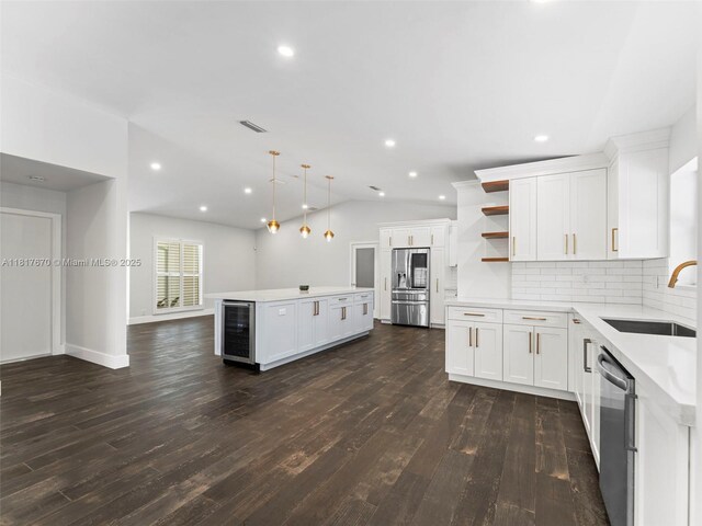 5976 SW 88th Pl, Miami, FL 33173 - kitchen featuring appliances with stainless steel finishes, open shelves, a kitchen island, beverage cooler, and dark wood-style flooring