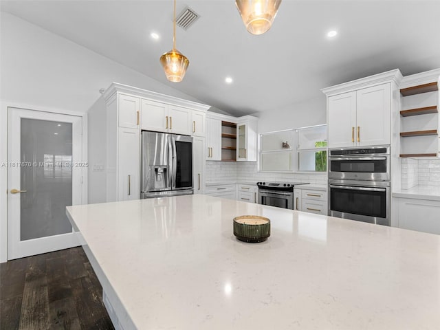 5976 SW 88th Pl, Miami, FL 33173 - kitchen with open shelves, stainless steel appliances, white cabinetry, tasteful backsplash, and lofted ceiling