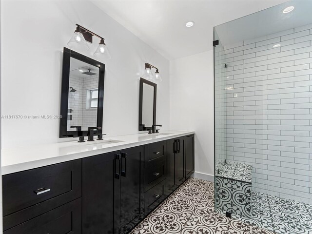 5976 SW 88th Pl, Miami, FL 33173 - bathroom featuring double vanity, a tile shower, recessed lighting, and tile patterned flooring