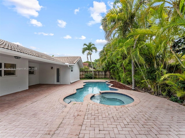 5976 SW 88th Pl, Miami, FL 33173 - view of swimming pool with a fenced backyard, a patio, and a pool with connected hot tub