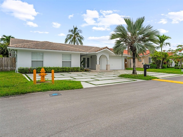 5976 SW 88th Pl, Miami, FL 33173 - view of front of house with a garage, stucco siding, a tiled roof, and concrete driveway