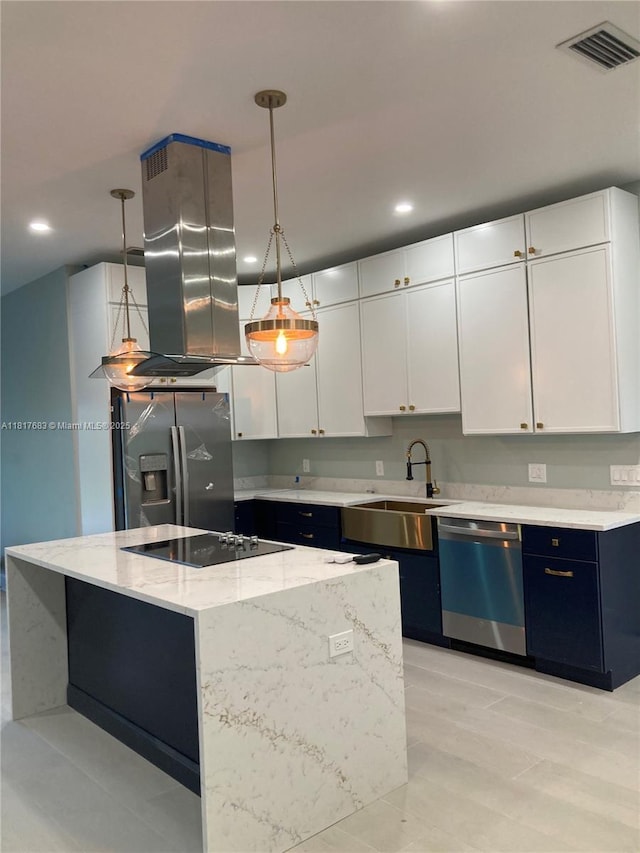 930 34th St, West Palm Beach, FL 33407 - kitchen featuring appliances with stainless steel finishes, a sink, white cabinetry, recessed lighting, and decorative light fixtures