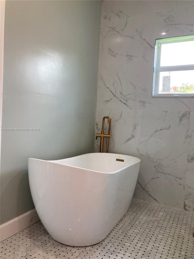 930 34th St, West Palm Beach, FL 33407 - full bathroom featuring a soaking tub and baseboards