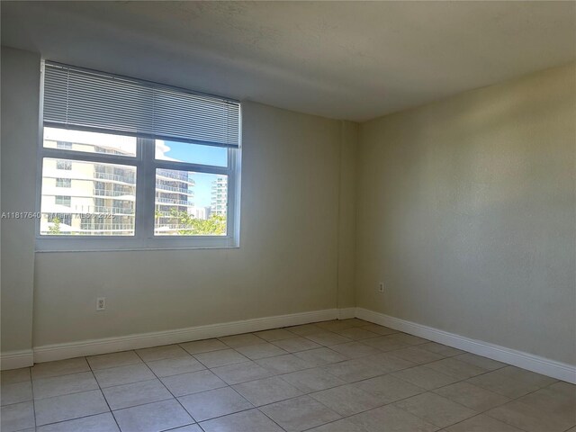 10350 W Bay Harbor Dr Unit 4F, Bay Harbor Islands, FL 33154 - spare room with light tile patterned floors
