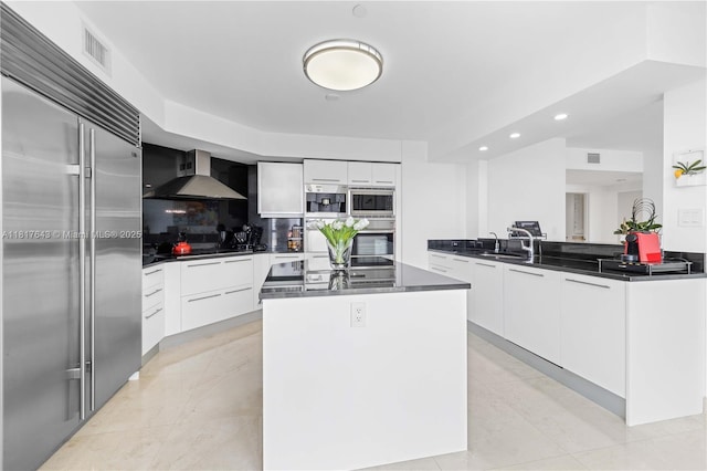 1331 Brickell Bay Dr Unit 4001, Miami, FL 33131 - kitchen with modern cabinets, appliances with stainless steel finishes, wall chimney exhaust hood, dark countertops, and recessed lighting