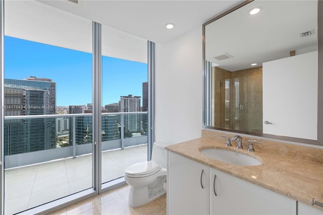 1331 Brickell Bay Dr Unit 4001, Miami, FL 33131 - full bathroom with vanity, tile patterned flooring, a wall of windows, a city view, and recessed lighting