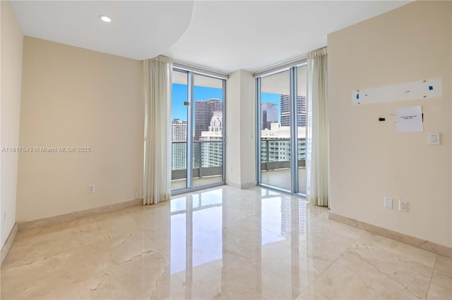 1331 Brickell Bay Dr Unit 4001, Miami, FL 33131 - unfurnished room with a wall of windows, light marble finish floors, and a city view
