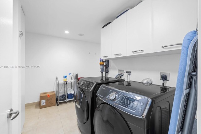 1331 Brickell Bay Dr Unit 4001, Miami, FL 33131 - washroom with cabinet space, independent washer and dryer, light tile patterned floors, and recessed lighting