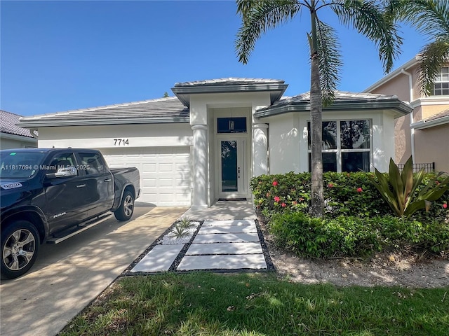 7714 NW 70th Way, Parkland, FL 33067 - view of front of property with stucco siding, an attached garage, and concrete driveway