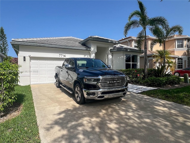 7714 NW 70th Way, Parkland, FL 33067 - view of front of house with driveway, a garage, a tiled roof, and stucco siding