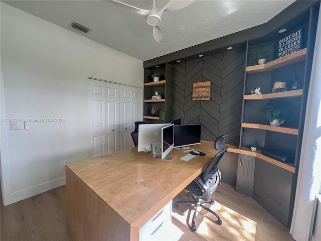 7714 NW 70th Way, Parkland, FL 33067 - office area featuring light wood-style flooring, ceiling fan, and a textured ceiling