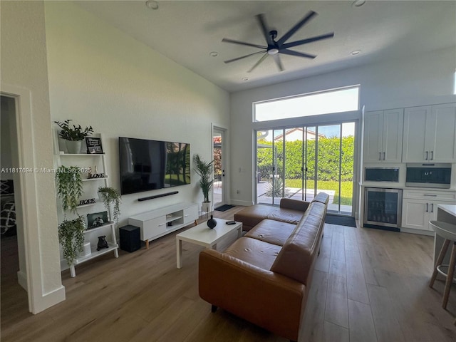 7714 NW 70th Way, Parkland, FL 33067 - living area featuring wine cooler, wood finished floors, a towering ceiling, and ceiling fan