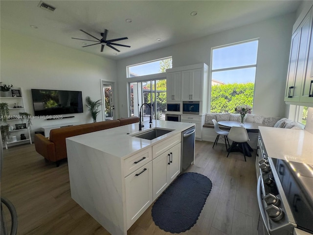 7714 NW 70th Way, Parkland, FL 33067 - kitchen with appliances with stainless steel finishes, light countertops, wood finished floors, and recessed lighting