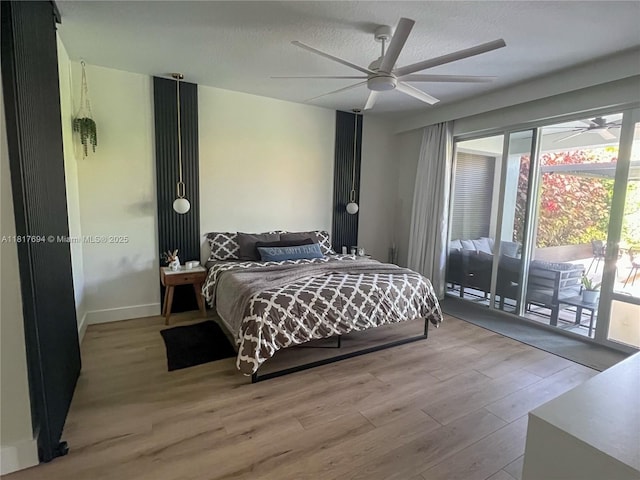 7714 NW 70th Way, Parkland, FL 33067 - bedroom featuring access to exterior, wood finished floors, a textured ceiling, and ceiling fan