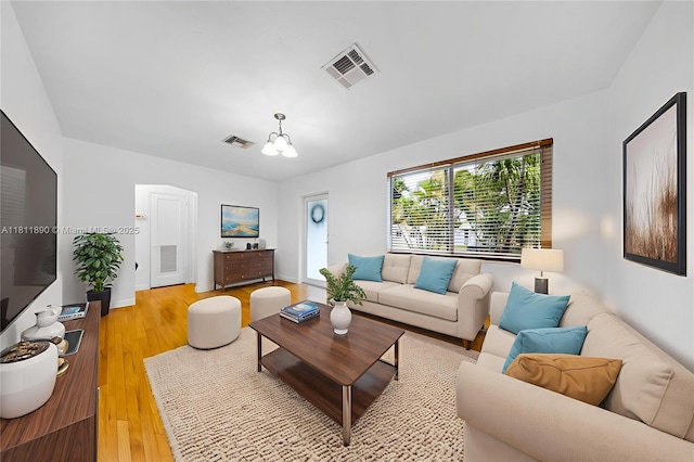 81 Hough Dr, Miami Springs, FL 33166 - living area with a chandelier and light wood-style floors