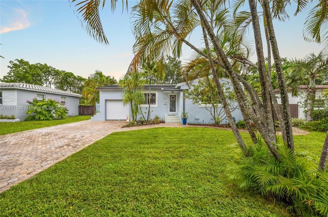 81 Hough Dr, Miami Springs, FL 33166 - view of front of house with decorative driveway, stucco siding, and a garage