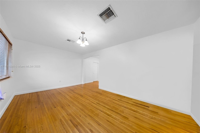 81 Hough Dr, Miami Springs, FL 33166 - empty room with a chandelier and light wood-type flooring