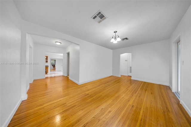 81 Hough Dr, Miami Springs, FL 33166 - empty room featuring a chandelier and light wood-style flooring