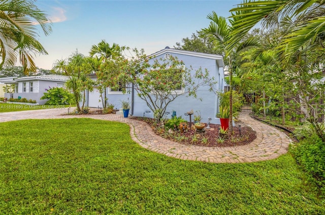 81 Hough Dr, Miami Springs, FL 33166 - view of front of house featuring stucco siding, a front yard, and decorative driveway