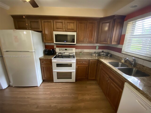 6200 NW 44th St Unit 115, Lauderhill, FL 33319 - kitchen featuring white appliances, a sink, light wood-type flooring, brown cabinetry, and a ceiling fan