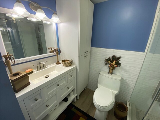 6200 NW 44th St Unit 115, Lauderhill, FL 33319 - full bath featuring vanity, toilet, a stall shower, and tile walls