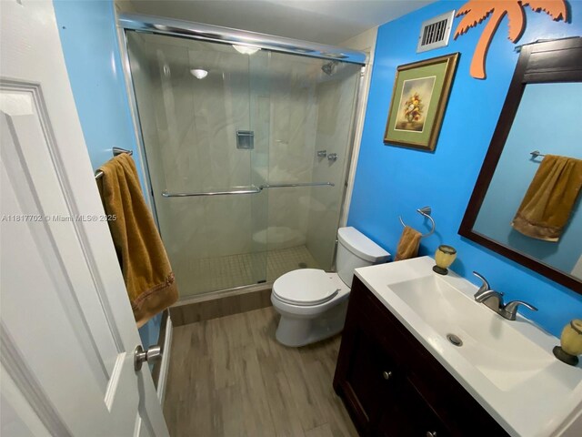 6200 NW 44th St Unit 115, Lauderhill, FL 33319 - bathroom featuring wood finished floors, vanity, toilet, and a shower stall
