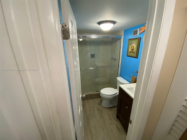 6200 NW 44th St Unit 115, Lauderhill, FL 33319 - full bath featuring vanity, toilet, a stall shower, and wood finished floors