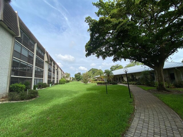 6200 NW 44th St Unit 115, Lauderhill, FL 33319 - view of community with a yard
