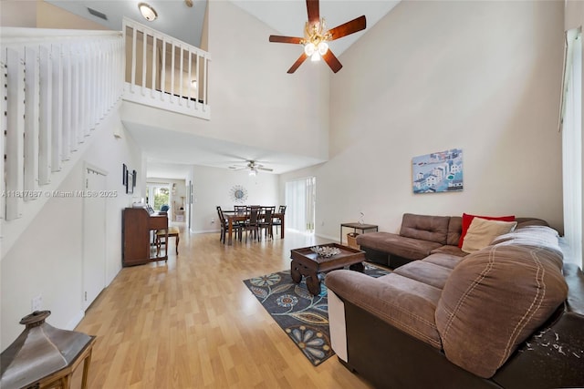 13344 NW 7th St, Plantation, FL 33325 - living area with a ceiling fan, wood finished floors, high vaulted ceiling, stairway, and baseboards