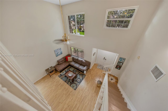13344 NW 7th St, Plantation, FL 33325 - living room with healthy amount of natural light, wood finished floors, a towering ceiling, a ceiling fan, and baseboards