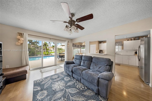 13344 NW 7th St, Plantation, FL 33325 - living room with light wood-type flooring, a ceiling fan, and a textured ceiling