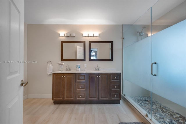 13344 NW 7th St, Plantation, FL 33325 - full bath with wood finished floors, double vanity, a shower stall, and baseboards