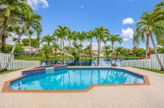 13344 NW 7th St, Plantation, FL 33325 - view of swimming pool with a water view and a pool with connected hot tub