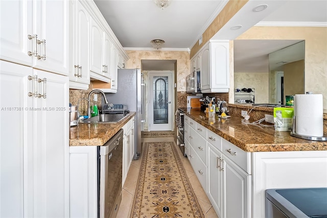 250 174th St Unit 1704, Sunny Isles Beach, FL 33160 - kitchen with appliances with stainless steel finishes, light tile patterned flooring, white cabinetry, a sink, and ornamental molding
