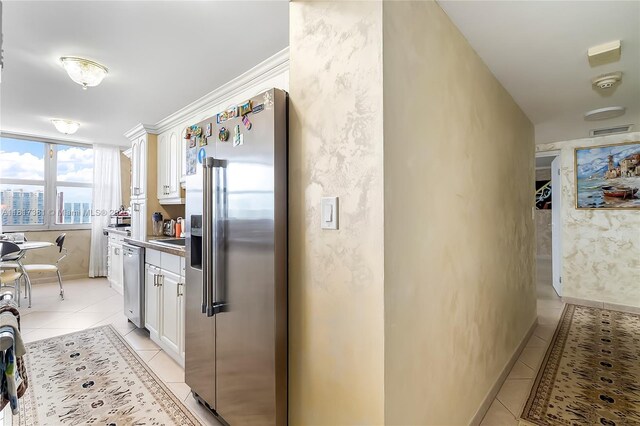 250 174th St Unit 1704, Sunny Isles Beach, FL 33160 - kitchen featuring stainless steel appliances, light tile patterned floors, and white cabinetry