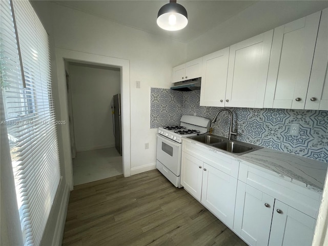 625 52nd St, West Palm Beach, FL 33407 - kitchen with white range with gas stovetop, a sink, dark wood-type flooring, tasteful backsplash, and under cabinet range hood