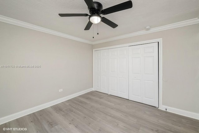 7244 SW 94th Pl Unit C1, Miami, FL 33173 - unfurnished bedroom with crown molding, wood finished floors, baseboards, a closet, and ceiling fan