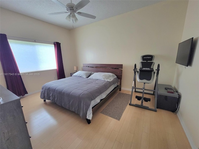 9575 Weldon Cir Unit C413, Tamarac, FL 33321 - bedroom featuring baseboards, wood finished floors, a textured ceiling, and ceiling fan