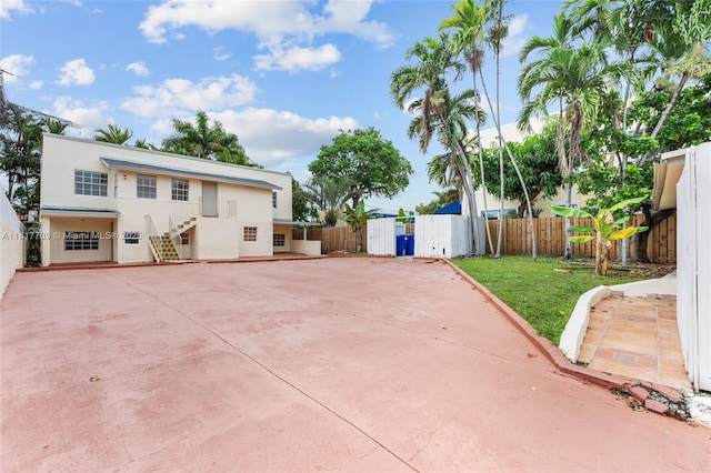 2385 SW 17th St, Miami, FL 33145 - rear view of property with stucco siding and stairway