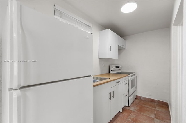 2385 SW 17th St, Miami, FL 33145 - kitchen featuring white appliances, white cabinetry, butcher block counters, and baseboards
