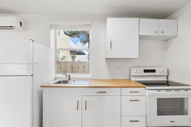 2385 SW 17th St, Miami, FL 33145 - kitchen with white appliances, a wall mounted air conditioner, a sink, and white cabinetry