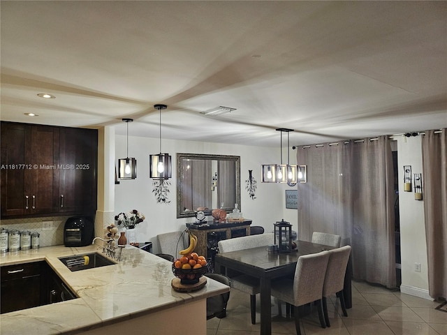 10270 NW 46th St, Doral, FL 33178 - dining room with light tile patterned floors, recessed lighting, and bar with sink