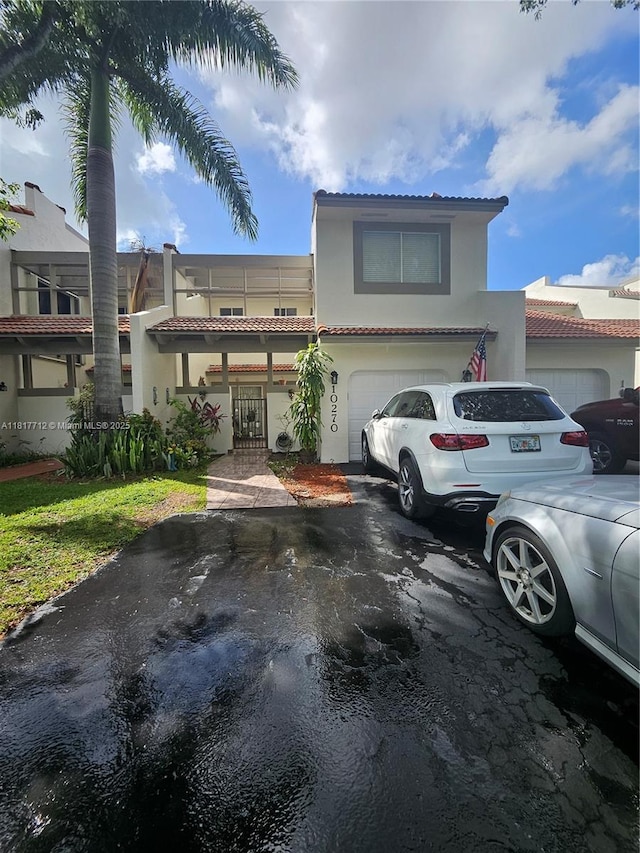 10270 NW 46th St, Doral, FL 33178 - view of front of property with stucco siding, a tiled roof, driveway, and a garage
