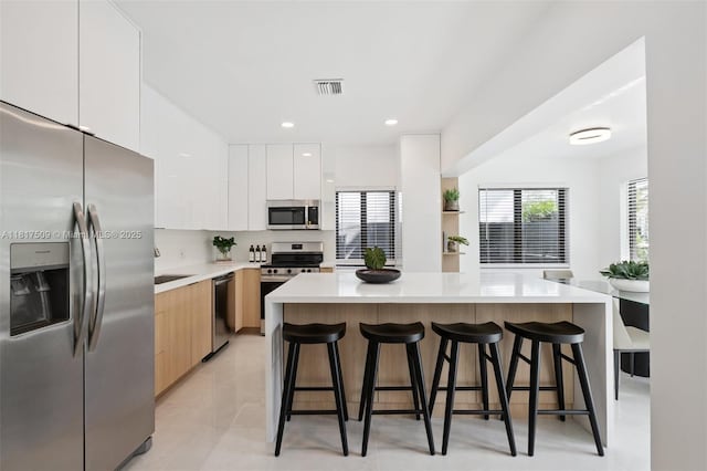 326 SW 20th Rd, Miami, FL 33129 - kitchen with stainless steel appliances, modern cabinets, a kitchen breakfast bar, a center island, and recessed lighting