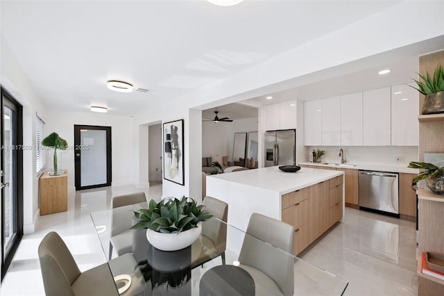 326 SW 20th Rd, Miami, FL 33129 - kitchen featuring appliances with stainless steel finishes, modern cabinets, light countertops, white cabinets, and recessed lighting