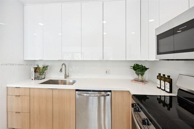 326 SW 20th Rd, Miami, FL 33129 - kitchen featuring modern cabinets, appliances with stainless steel finishes, and light countertops