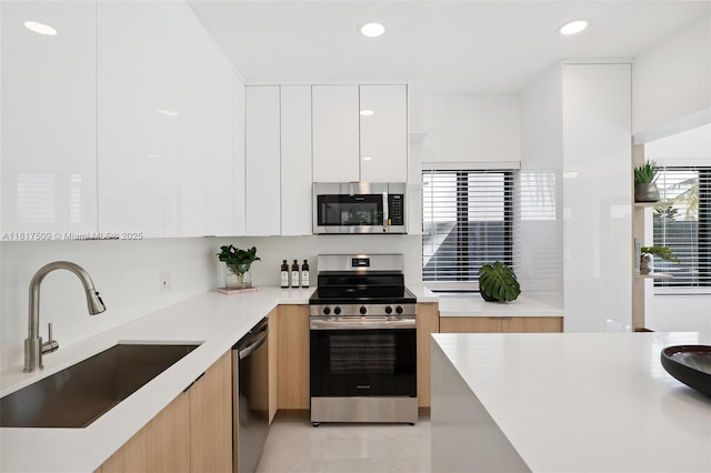 326 SW 20th Rd, Miami, FL 33129 - kitchen featuring stainless steel appliances, modern cabinets, white cabinets, light countertops, and recessed lighting