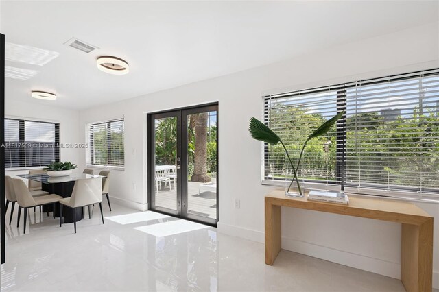 326 SW 20th Rd, Miami, FL 33129 - dining area with light tile patterned floors and french doors