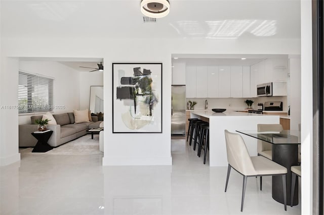 326 SW 20th Rd, Miami, FL 33129 - dining room with light tile patterned floors and ceiling fan