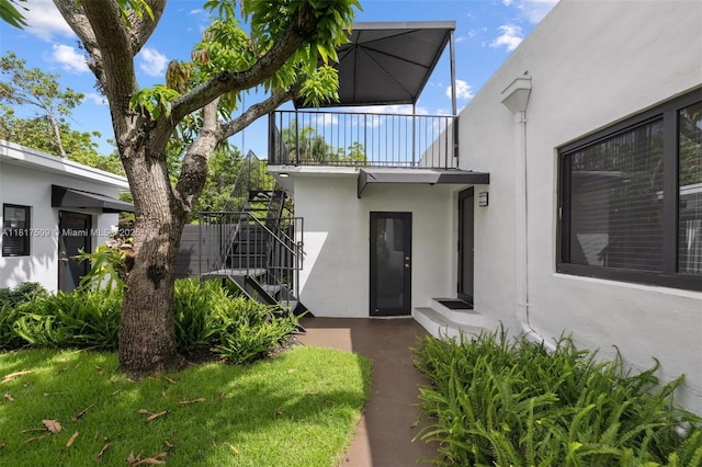 326 SW 20th Rd, Miami, FL 33129 - view of exterior entry featuring stucco siding and a balcony
